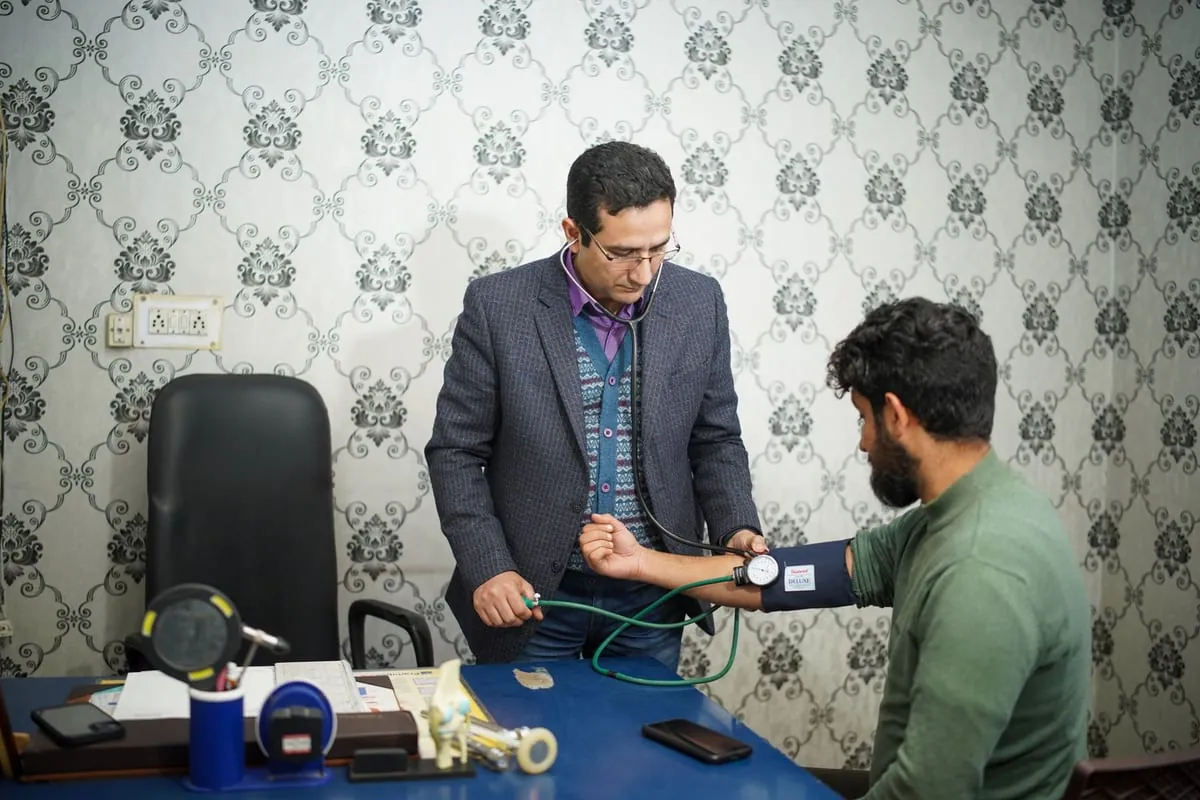 A doctor checking a patient's blood pressure